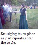 Smudging takes place as participants enter the circle.